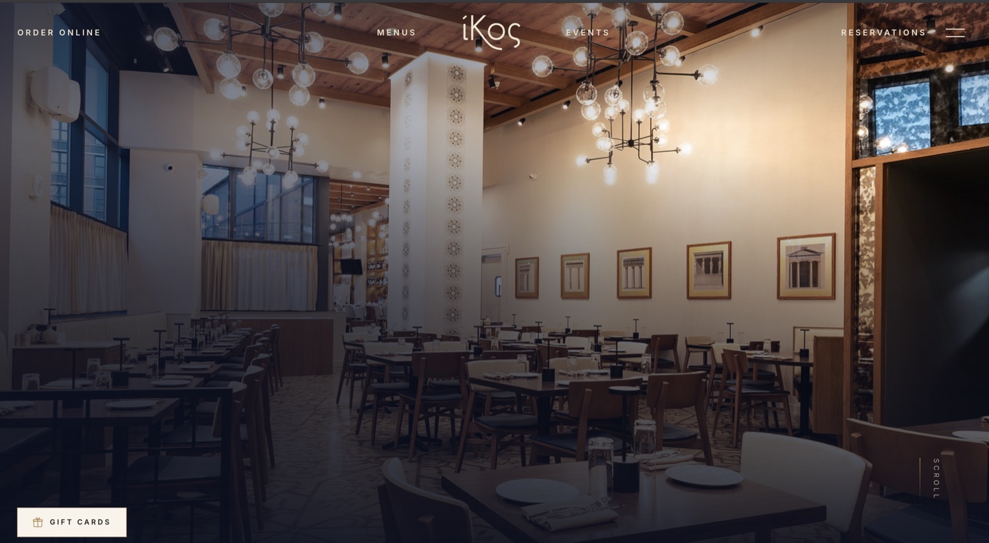 IKOS home page: warmly lit dining room